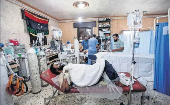  ??  ?? Money talks: Medical centres in conflict-riddled Libya (above) are recruiting Ugandan health profession­als to work in a number of fields, but critics say that ‘exporting’ doctors will compound the crisis in Uganda’s struggling hospitals and clinics...
