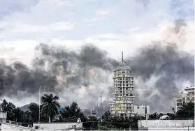  ?? Hector Parra / Associated Press ?? Smoke from burning cars mars the skyline of Culiacan, Mexico, where residents waited and hid for hours as gangs forced the government to free a drug lord’s son.