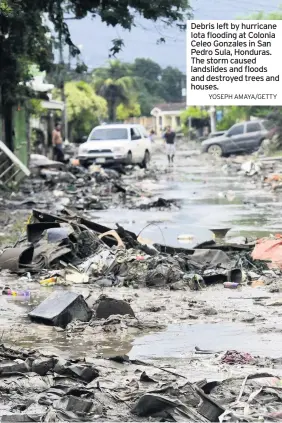  ?? YOSEPH AMAYA/GETTY ?? Debris left by hurricane Iota flooding at Colonia Celeo Gonzales in San Pedro Sula, Honduras. The storm caused landslides and floods and destroyed trees and houses.