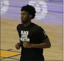  ?? JEFF CHIU — THE ASSOCIATED PRESS ?? Warriors center James Wiseman wears a Black Lives Matter shirt as he warms up before a game against the Toronto Raptors in San Francisco on Sunday.