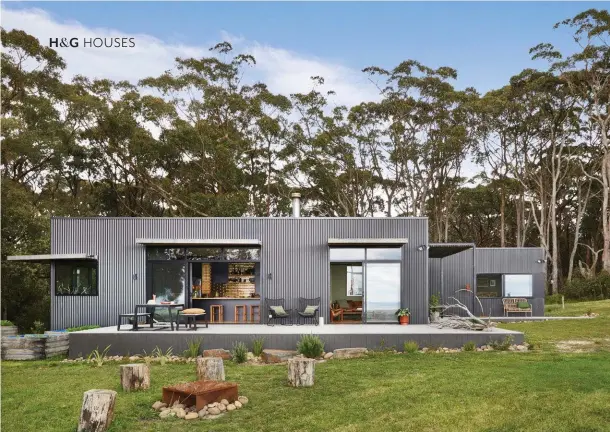  ??  ?? MAIN DECK/LAWN “The kitchen splashback looks amazing when you’re outside at sunrise and the light’s reflecting off it,” says Simone. To the left of the deck are a number of old carrot-planting boxes filled with premium topsoil for growing vegetables. Native grasses planted around the decks attract birdlife. A large mob of kangaroos visit at dawn and again at dusk to eat the grass, and there is a wombat happily in residence under the house. The ‘Zen’ steel fire pit (in the foreground) from Remarkable Outdoor Living sees plenty of use. It rusted to the orange-red colour over time. REAR DECK Simone loves relaxing in her beautiful stone bath, built into the deck. “It weighs about 300kg!” she says. Designer buy: ‘Castello’ bath, $3462, Natural Stone Bath Factory. Milli ‘Inox’ outdoor shower in marine-grade stainless steel, Reece. The deck’s periphery is lined with fire-retardant James Hardie fibre-cement cladding.