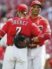  ?? AP ?? Joey Votto hugs Eugenio Suarez after a 7-3 victory Wednesday. The Reds have won consecutiv­e series against the Cardinals for the first time since 2011.