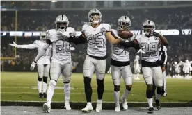  ?? Photograph: Lachlan Cunningham/Getty Images ?? Oakland’s Erik Harris (25) celebrates with teammates after intercepti­ng a pass by Philip Rivers in the second quarter.