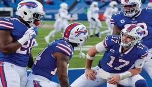  ?? The Associated Press ?? Buffalo Bills’ Josh Allen (17) celebrates with teammate Stefon Diggs (14), Dion Dawkins (73), and Zack Moss (20) after connecting with Diggs for a touchdown during the second half of Saturday’s wild-card playoff game against the Indianapol­is Colts in Orchard Park, N.Y.