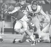  ??  ?? ALABAMA quarterbac­k Jalen Hurts breaks a tackle on one of his two third-quarter touchdown runs.