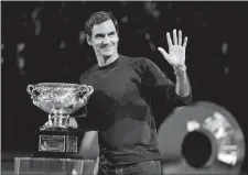  ?? MARK BAKER/AP PHOTO ?? Defending men’s champion Roger Federer waves to the crowd during a ceremony for the official draw at the Australian Open on Thursday.