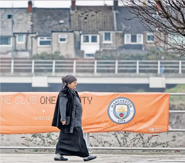  ??  ?? Cup build-up: A banner by the city’s River Usk promoting tonight’s tie; the temporary stand at Rodney Parade (left); fan David Sims (right) with a programme for a 1946 Newport v City game; the away dressing room, and (far left) manager Michael Flynn