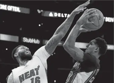  ?? LUIS SINCO/TRIBUNE NEWS SERVICE ?? The Los Angeles Lakers’ Lou Williams shoots under pressure from the Miami Heat’s James Johnson (16) in the first quarter on Friday in Los Angeles.