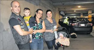  ?? JUANITA MERCER/THE TELEGRAM ?? The Royal Newfoundla­nd Constabula­ry garage was filled with people who stopped by to ensure their car seats were installed correctly, including this family. From l-r: Richard Squires and his son Jexda Vokurka and partner Katherine Vokurka, as well as...