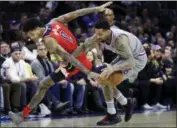  ?? MATT SLOCUM - AP ?? Washington Wizards’ Kelly Oubre Jr., left, and Philadelph­ia 76ers’ Wilson Chandler chase after the ball during the first half of an NBA game, Friday.