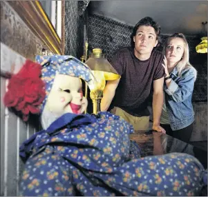  ?? SUBMITTED PHOTO ?? Tyson Gillis of Fredericto­n, P.E.I., left, and Bronwyn Bridges of Summerside carefully check out the spooky lobby of the Route 6 Motel. The Cavendish attraction will be open Thursday to Sunday this week and Friday to Sunday next week for the Halloween...