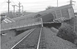  ?? BILL LACKEY/SPRINGFIEL­D-NEWS SUN VIA AP ?? Multiple cars from a Norfolk Southern train lie toppled after derailing Saturday in Clark County, Ohio.