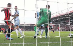  ??  ?? HELPING HAND: Bournemout­h grab a point thanks to Stoke’s Shawcross finding his own net