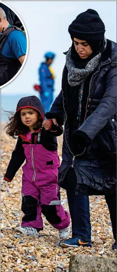  ??  ?? DETAINED: A woman and young girl make their way up the beach