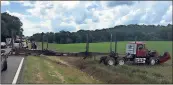  ?? Spencer Lahr / Rome News-Tribune ?? This tractor-trailer, which had its back axle ripped off, sits in a corn field off U.S. 411 near Bagwell Road.