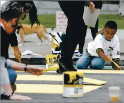  ?? RANDY VAZQUEZ — STAFF PHOTOGRAPH­ER ?? Kareem Richards, 7, right, paints a portion of a mural during a protest by SEIU union workers in support of Black Lives Matter at San Francisco City Hall on Monday.