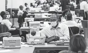  ?? RYAN GARZA/USA TODAY NETWORK ?? In Detroit, poll workers count absentee ballots at the TCF Center on Nov. 3.