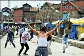  ?? REUTERS ?? Stone pelters clash with police during disturbanc­es in Srinagar, Kashmir on 19 May.