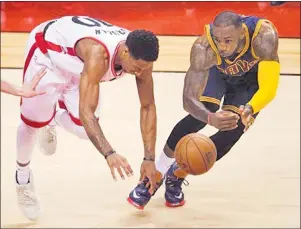  ?? AP PHOTO ?? In this May 2016 file photo, Cleveland Cavaliers forward LeBron James (right) steals the ball from Toronto Raptors guard DeMar DeRozan during the first half of Game 6 of the NBA basketball Eastern Conference finals in Toronto.