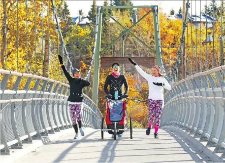  ?? GAVIN YOUNG ?? From left, Kitty Honeychurc­h, Leah Brooks and Linda Kepler cheer the sunny weather as they jog across the Rideau Park Bridge Sunday morning. The week ahead looks good too, with a ridge of high pressure expected to bring clear skies and highs in the double digits.