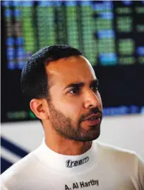  ?? – Supplied Photo ?? ALL GEARED UP: Oman Racing Team driver Ahmad Al HArthy looks up at the screen after practice.