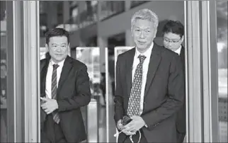  ?? SINGAPORE
-AFP ?? Lee Hsien Yang (right) leaves the Singapore Supreme Court.