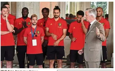  ?? — AFP ?? Well done, boys: King Philippe (second from right) talking to the Belgium players at the Royal castle in Laken, Brussels, yesterday.