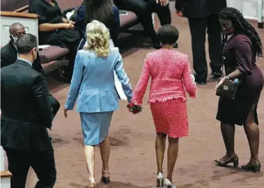  ?? Tracy Glantz/The State / Associated Press ?? First lady Jill Biden and Robin Jackson walk hand-in-hand on Oct. 17 at Brookland Baptist Church in West Columbia, S.C. Biden credits Jackson for restoring her faith after her son, Beau, died of brain cancer in 2015.