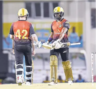  ?? PHOTO BY RANDY BROOKS – CPL T20/GETTY IMAGES ?? Brendon McCullum (left) and Darren Bravo of Trinbago Knight Riders meet in mid-pitch during Match 9 of the Hero Caribbean Premier League between St Lucia Stars and Trinbago Knight Riders at the Darren Sammy Cricket Ground on Thursday night.