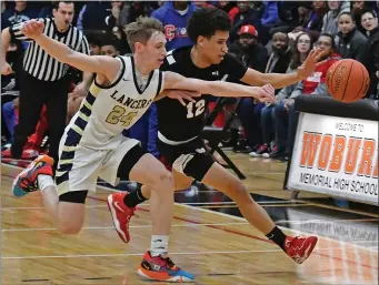  ?? STAFF PHOTO BY CHRIS CHRISTO — MEDIANEWS GROUP/BOSTON HERALD ?? WOBURN, MA - March 13, 2023: Charlestow­n’s Ricky Cabral and Malden Catholic’s Matthew Gaffney compete for a loose ball.