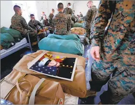  ??  ?? After graduation at the Marine Corps Recruit Depot, Colton Weidner receives a portrait of himself he hadn’t seen before. It was him in his Marine dress blue uniform.