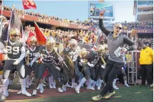  ?? PHOTO CREDIT ?? Coach P.J. Fleck leads Minnesota on the field prior to its rout of Maryland last week. The Gophers are 8-0, ranked 13th and host No. 5 Penn State on Saturday.