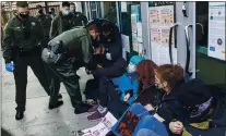  ?? PHOTO BY ANDA CHU — STAFF PHOTOGRAPH­ER ?? Officers with the Santa Clara County Sheriff’s Office remove protesters blocking a doorway after declaring the gathering an unlawful assembly at the Santa Clara County Superior Court.