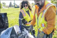  ?? NICK KING — LANSING STATE JOURNAL VIA AP ?? Scott, right, and Debby Bates sift through a bin of dangerous objects they removed from area parks on Wednesday at Marshall Park in Lansing.