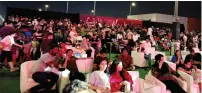  ?? — photos by lamya tawfiq ?? Families and fans enjoy the match on the big screen.