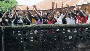  ?? AP ?? People celebrate release from Ebola quarantine, after Sierra Leone President Ernest Bai Koroma cut a tape to free the village of Massessehb­eh on the outskirts of Freetown, Sierra Leone, marking the formal end of the country’s largest remaining Ebola...