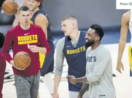  ?? ?? Denver Nuggets centre Nikola Jokic, centre, jokes around with forwards Vlatko Cancar (left) and Jeff Green during practice ahead of Game 1 of the NBA basketball finals against the Miami Heat Wednesday, May 31, 2023, in Denver.