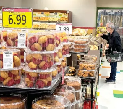  ?? JUSTIN SULLIVAN/GETTY IMAGES ?? A customer shops for food at a grocery store on March 12 in San Rafael, California. According to a report by the Bureau of Labor and Statistics, inflation rose by 3.2% for the 12 months ended in February, up slightly from January’s 3.1%.