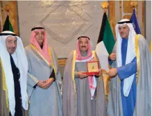  ??  ?? KUWAIT: His Highness the Amir Sheikh Sabah Al-Ahmad Al-Jaber Al-Sabah receives a memorial specie from Informatio­n Minister Sheikh Salman Sabah Al-Salem Al-Humoud Al-Sabah, in presence of NCCAL officials Ali AlYouha and Mohammad Al-Asousi. — Amiri Diwan...