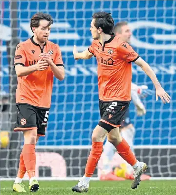  ??  ?? CONSOLATIO­N: Marc Mcnulty is congratula­ted on his late goal by Liam Smith.