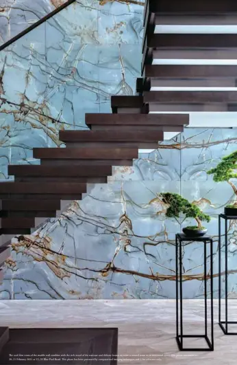  ??  ?? The cool blue tones of the marble wall combine with the rich wood of the staircase and delicate bonsai to evoke a natural scene in an interstiti­al space. This photo was taken on 20–21 February 2021 at 23–39 Blue Pool Road. This photo has been processed by computeris­ed imaging techniques and is for reference only.