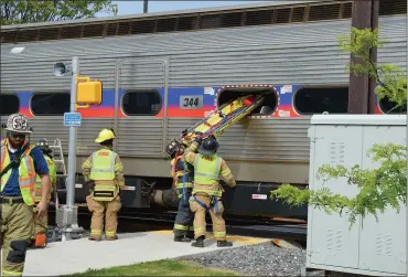  ?? RACHEL RAVINA — MEDIANEWS GROUP ?? Area firefighte­rs lift a stretcher into a SEPTA train Sunday morning during a training exercise at the station in downtown Lansdale.