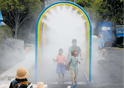  ?? Photo / AP ?? Tennis fans at the Australian Open were able to cool down at the Melbourne venue’s water-mist walkway.