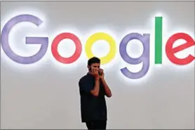  ?? PRAKASH SINGH/AFP ?? A man talks on his phone under the Google logo in New Delhi on September 27.