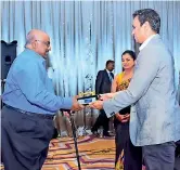  ??  ?? The keys being handed over to the owners by Group Chairman Hiran Hettiarach­chi