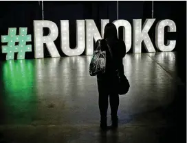  ?? [PHOTO BY DOUG HOKE, THE OKLAHOMAN] ?? A woman stops Friday to take a photo of the #runokc sign in the marathon expo at the Cox Convention Center.