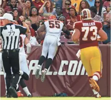  ?? ALEX BRANDON, AP ?? Bengals linebacker Vontaze Burfict (55) dives into the stands after returning an intercepti­on for a TD against Washington.