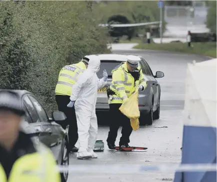  ??  ?? Forensic investigat­ors at the crime scene in the Berkshire village of Sulhamstea­d. Above right: Chief Constable John Campbell addresses the media