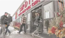  ??  ?? Customers enter Surdyk’s Liquor and Cheese Shop in Minneapoli­s on Sunday. The shop’s owner was fined for selling liquor on a Sunday — one day before Minnesota’s new law allowing such sales took effect.
| XAVIER WANG/ STAR TRIBUNE VIA AP