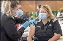  ?? KARL MONDON — STAFF PHOTOGRAPH­ER ?? Registered nurse Kjerstin Bakkeat gives a Covid-19booster shot to Clarita Cazarez in December. San Jose will now require its employees to get a coronaviru­s booster shot.